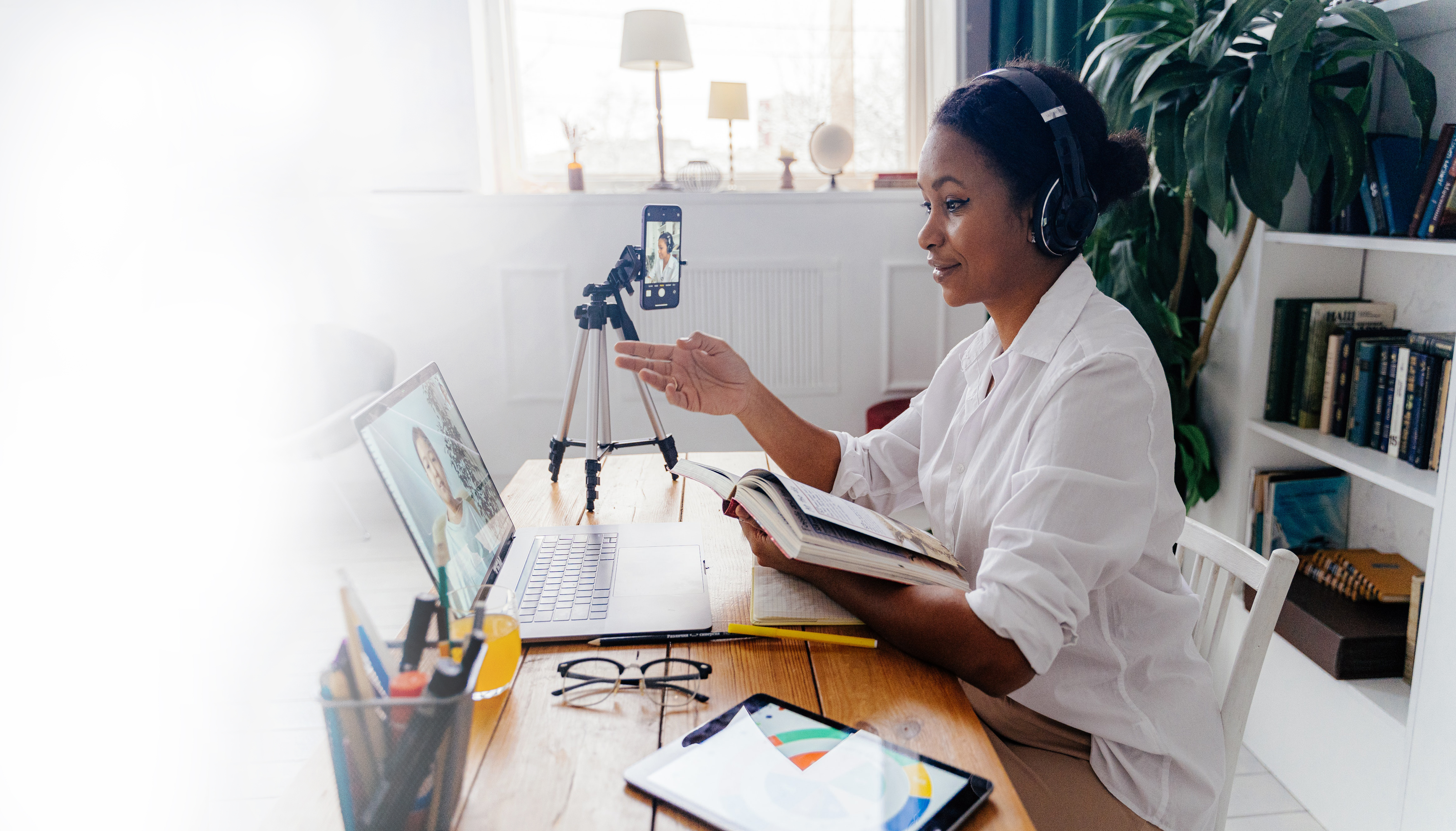 Motivated young professional delivering an impactful one-on-one coaching session while skillfully recording herself for strategic marketing purposes
