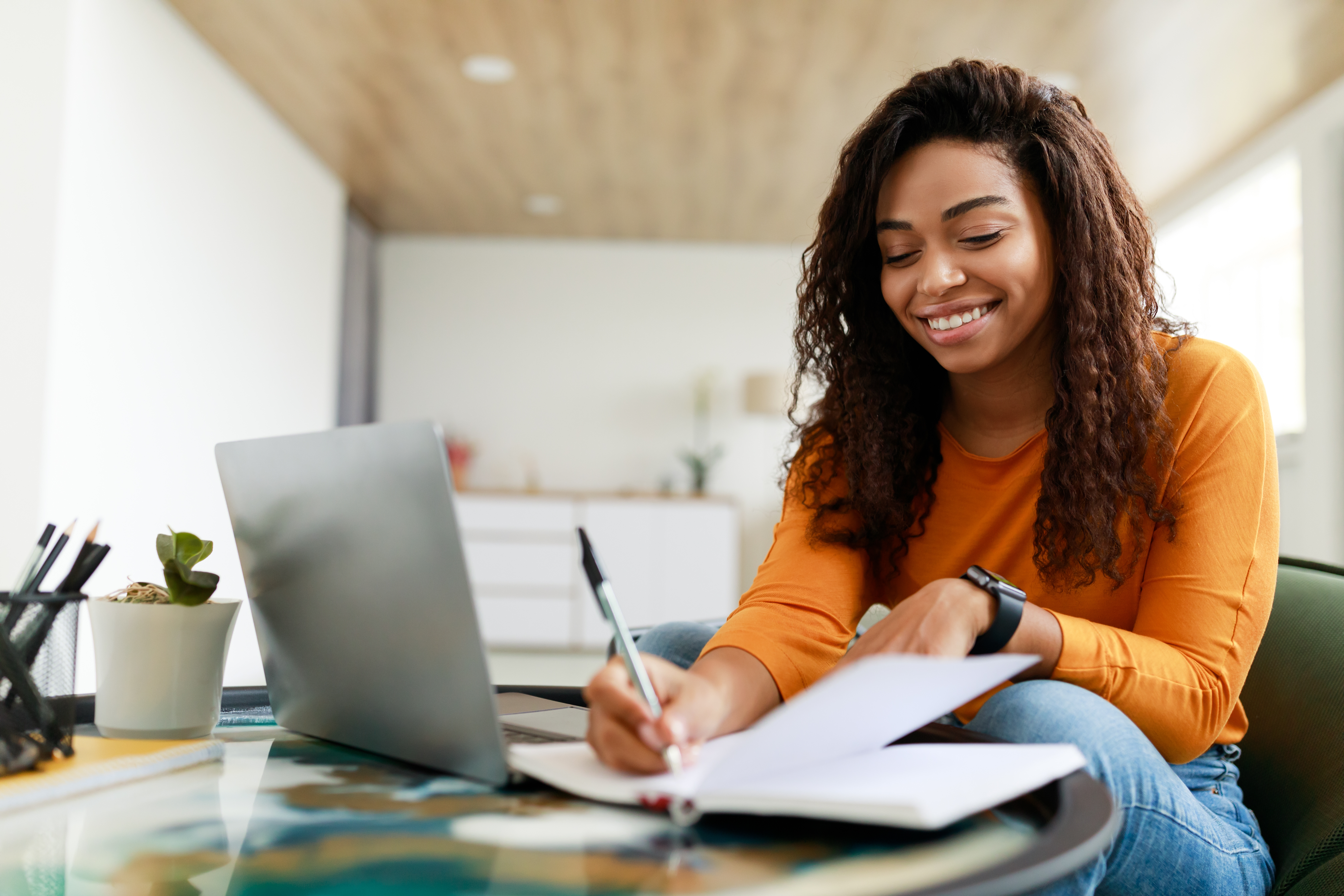 young black business corporate women smiling and writing